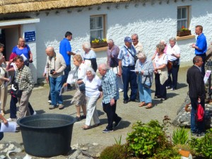 group of people walking around Glencolmcille Folk Village